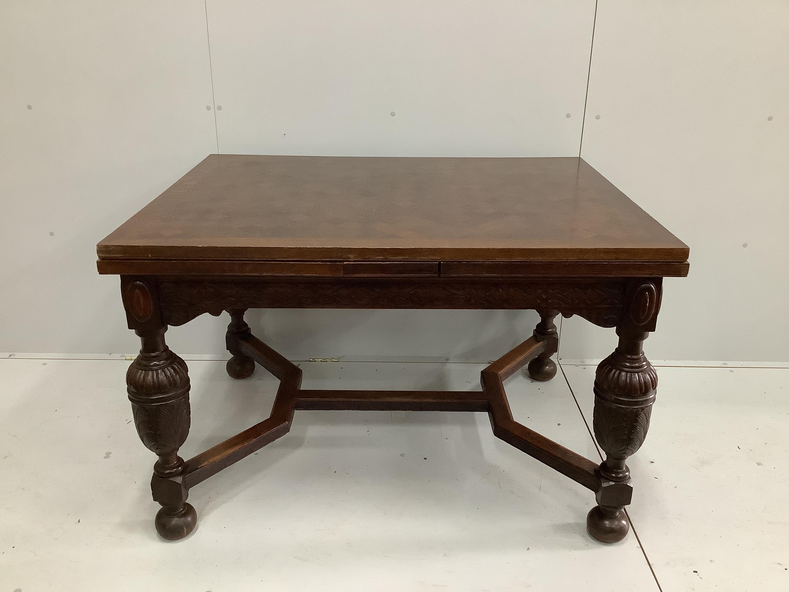 A Jacobean Revival parquetry inlaid rectangular oak draw leaf dining table, 220cm extended, depth 94cm, height 78cm together with six 1920's oak dining chairs, two with arms